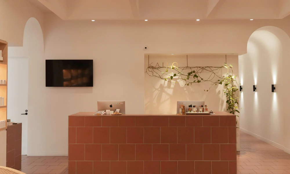KAILO Medispa Brisbane reception with terracotta counter and arched hallways.